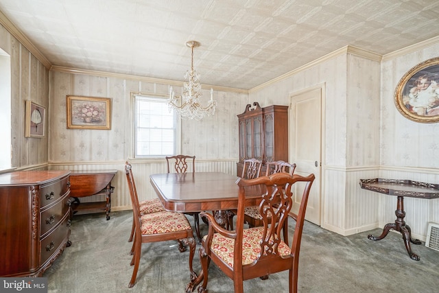 dining area with carpet, wainscoting, and wallpapered walls