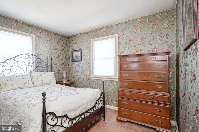 bedroom featuring wallpapered walls, baseboards, and carpet flooring