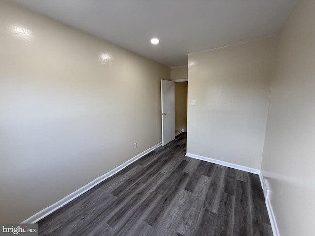 unfurnished room with recessed lighting, dark wood finished floors, and baseboards