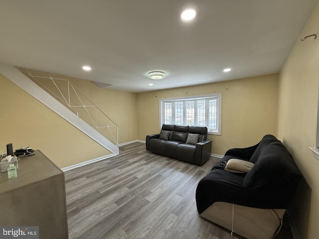 living area with stairway, recessed lighting, wood finished floors, and baseboards