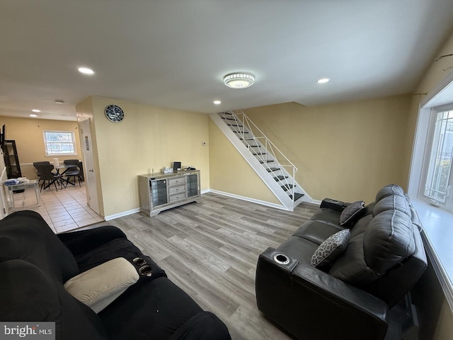 living area with stairs, baseboards, wood finished floors, and recessed lighting