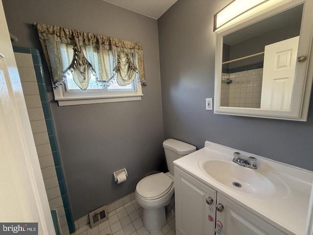 full bathroom with visible vents, tiled shower, toilet, tile patterned floors, and vanity