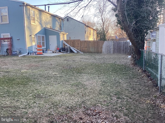 view of yard with a fenced backyard and a patio