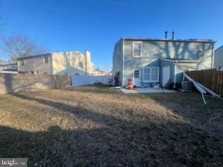 rear view of property featuring a fenced backyard