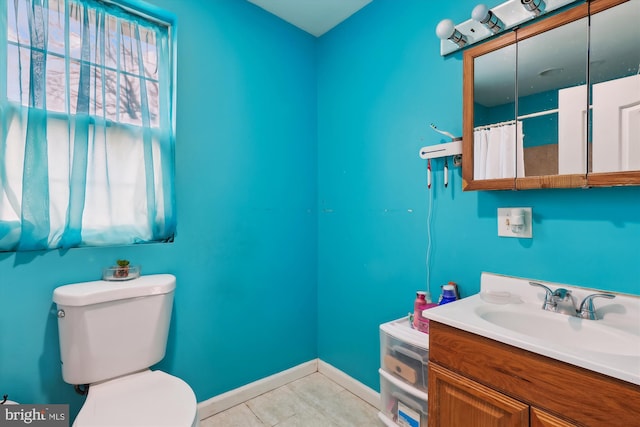 full bath featuring baseboards, toilet, tile patterned flooring, and vanity