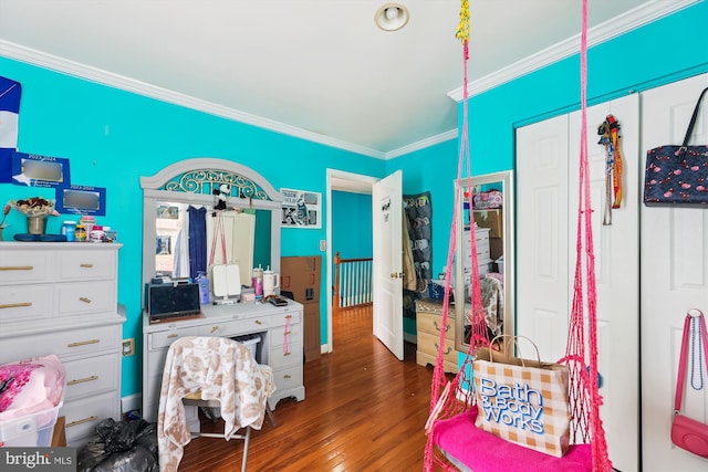 bedroom featuring wood finished floors and crown molding