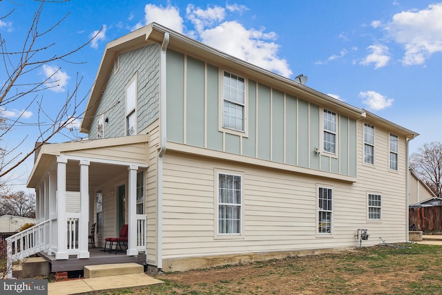 view of side of home featuring board and batten siding and a porch