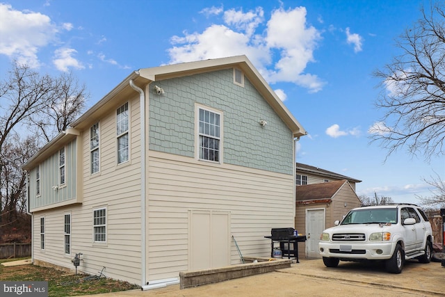 view of side of property with concrete driveway