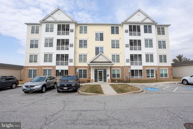 view of property featuring uncovered parking