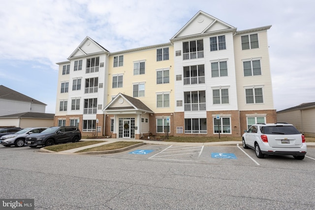 view of property featuring uncovered parking