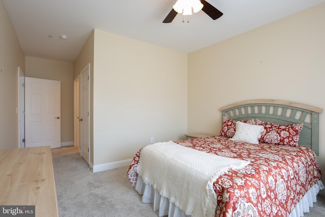 carpeted bedroom featuring ceiling fan and baseboards