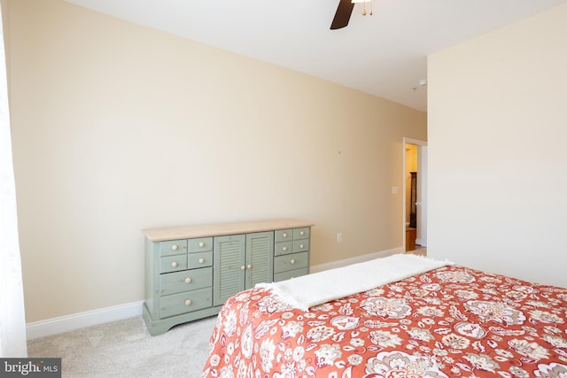 bedroom featuring baseboards, a ceiling fan, and light colored carpet