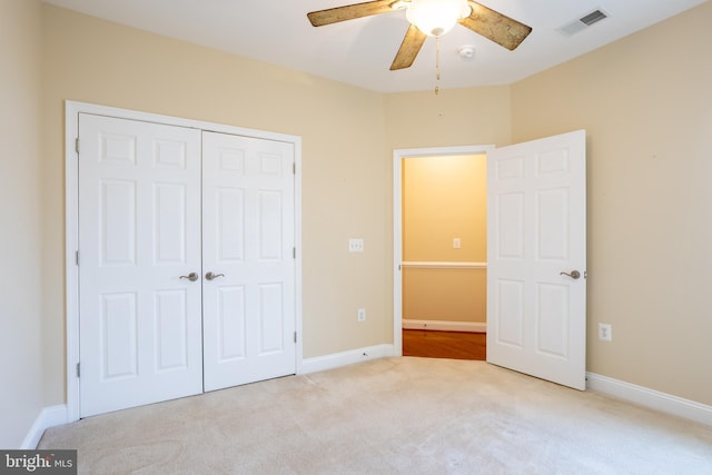 unfurnished bedroom with a closet, carpet flooring, visible vents, and baseboards