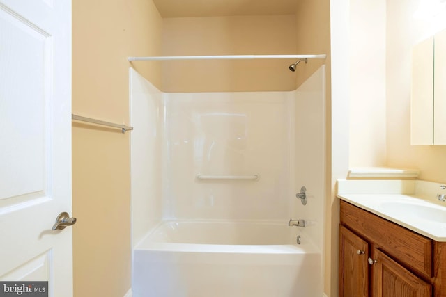 bathroom featuring  shower combination and vanity