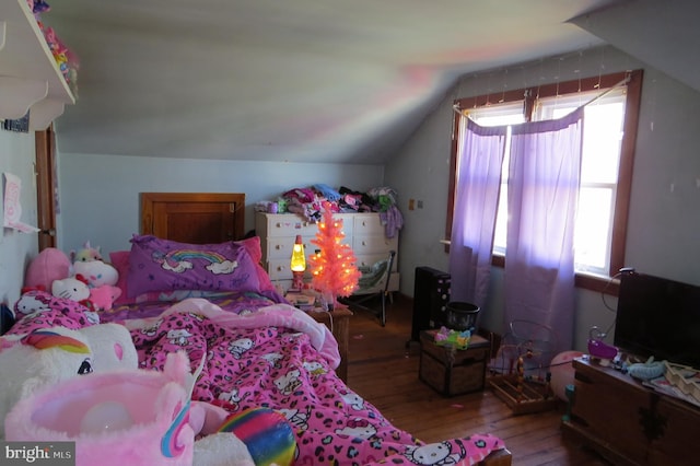 bedroom featuring lofted ceiling and hardwood / wood-style flooring