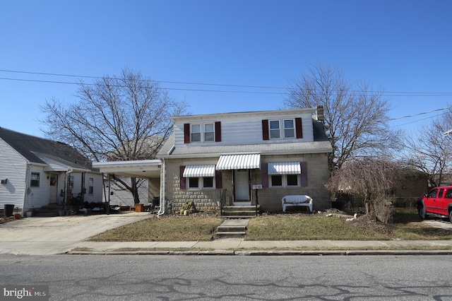 view of front of property with driveway, an attached carport, and entry steps