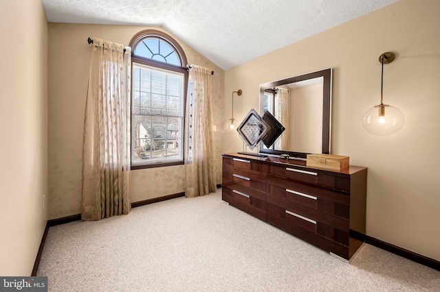 bedroom with lofted ceiling, baseboards, a textured ceiling, and light colored carpet