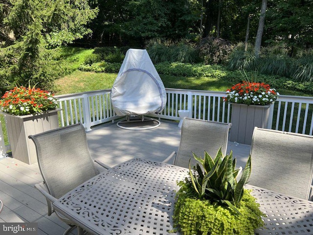 wooden terrace featuring outdoor dining area