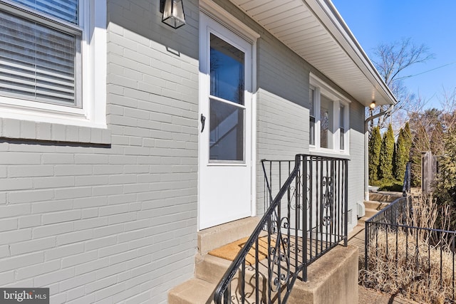 view of exterior entry with brick siding