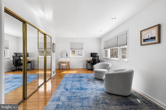 living area featuring recessed lighting, baseboards, and wood finished floors