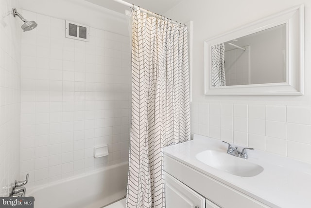 full bath with tile walls, visible vents, shower / bath combination with curtain, and vanity