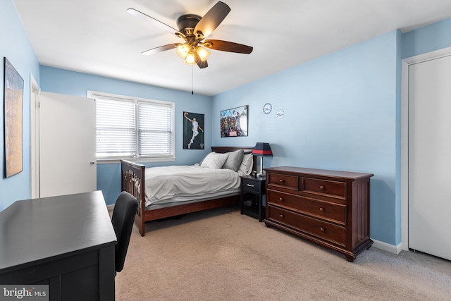 bedroom with a ceiling fan and light colored carpet