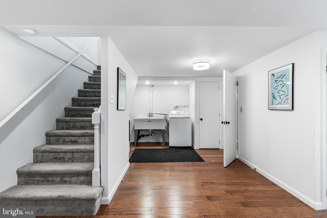 stairway with baseboards, washer / clothes dryer, and wood finished floors