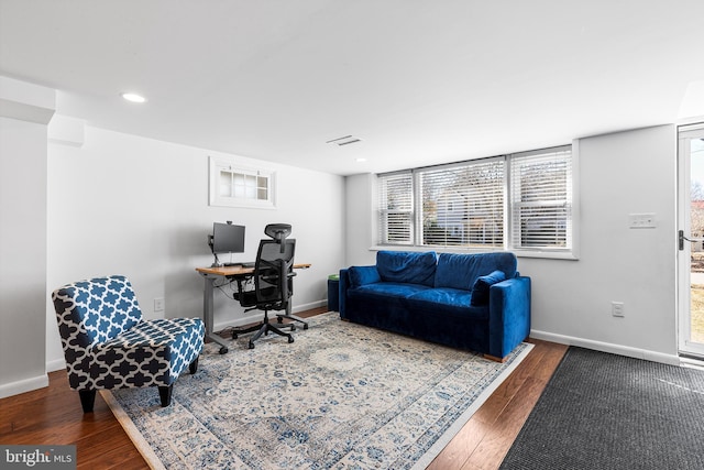 office featuring baseboards, wood finished floors, and recessed lighting