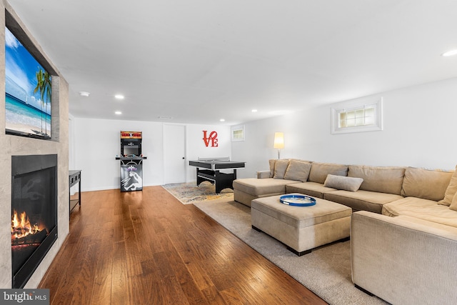 living room with a fireplace, hardwood / wood-style floors, and recessed lighting