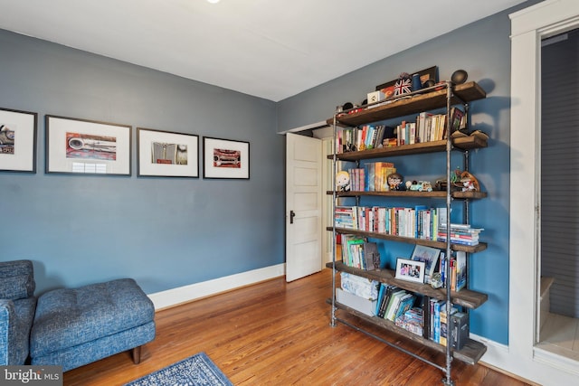 sitting room featuring baseboards and wood finished floors