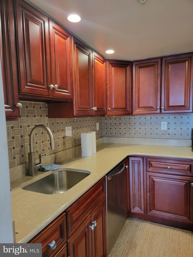 kitchen with stainless steel dishwasher, a sink, and dark brown cabinets