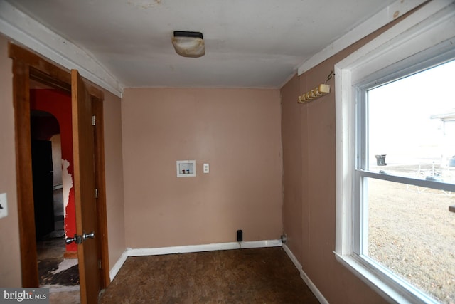 clothes washing area featuring baseboards, laundry area, washer hookup, and a healthy amount of sunlight