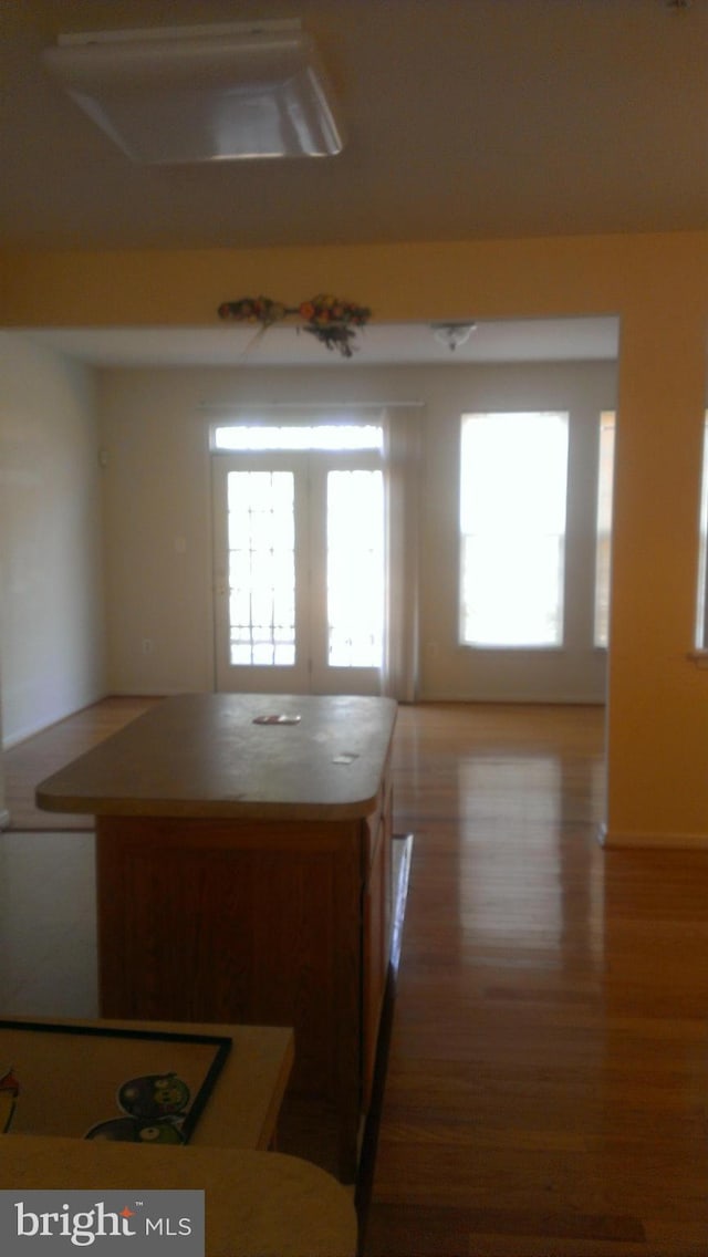 kitchen with open floor plan, wood finished floors, and a center island