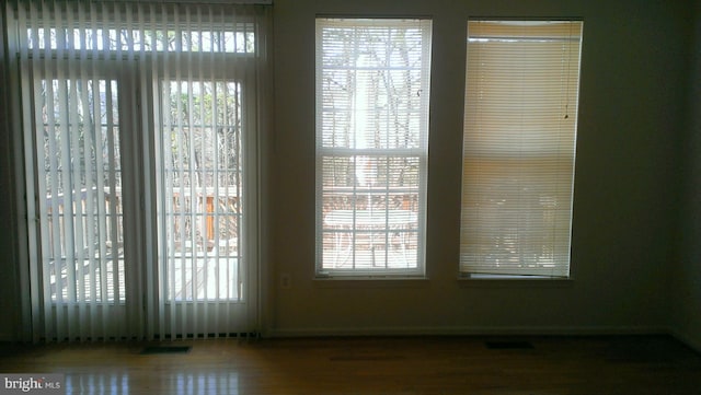 interior space with wood finished floors and visible vents