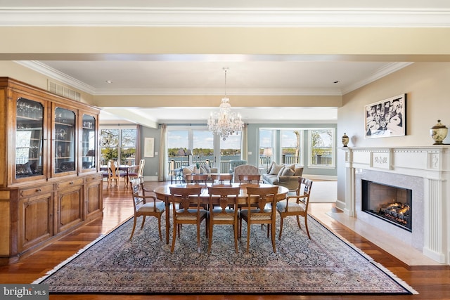 1900 Carrollton Rd, Annapolis, MD 21409 - dining space with a premium fireplace, a chandelier, baseboards, wood finished floors, and ornamental molding
