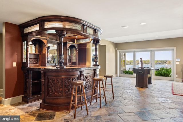 1900 Carrollton Rd, Annapolis, MD 21409 - bar featuring recessed lighting, baseboards, a bar, and stone tile flooring