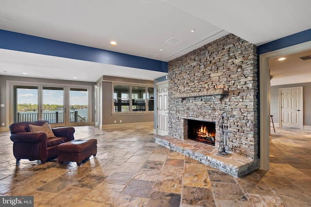 1900 Carrollton Rd, Annapolis, MD 21409 - living room featuring a stone fireplace, stone tile floors, recessed lighting, baseboards, and visible vents