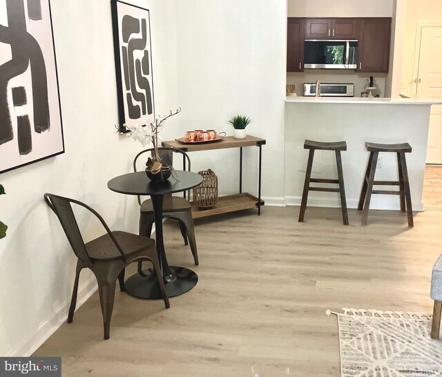 12919 Alton Sq Unit 120, Herndon, VA 20170 - dining room with light wood-style floors and baseboards