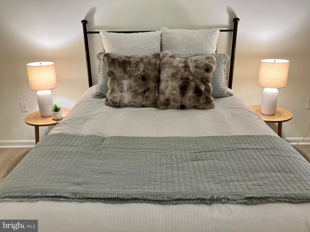 12919 Alton Sq Unit 120, Herndon, VA 20170 - bedroom with baseboards and wood finished floors
