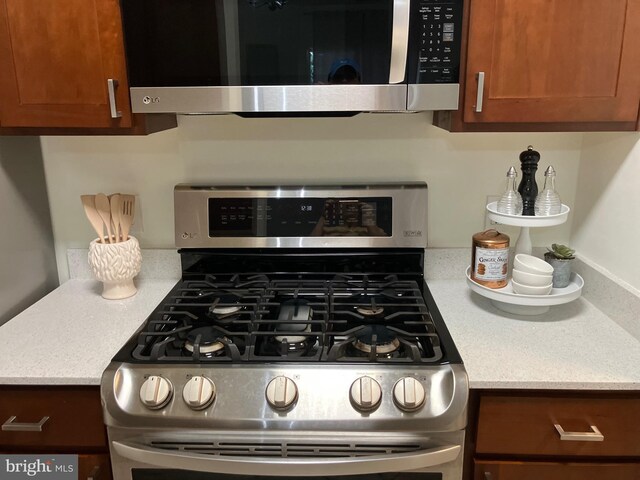12919 Alton Sq Unit 120, Herndon, VA 20170 - kitchen with stainless steel appliances, light countertops, and brown cabinets