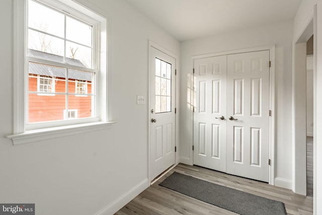 entryway featuring wood finished floors and baseboards