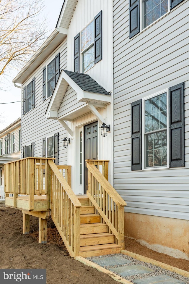 entrance to property featuring a deck and board and batten siding