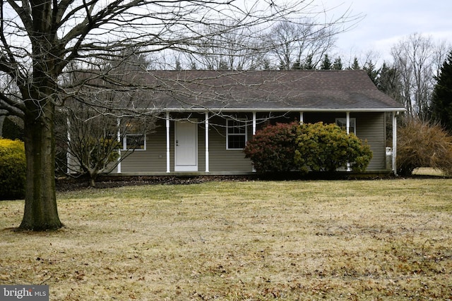 single story home with a shingled roof and a front lawn