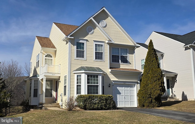 traditional home with aphalt driveway and a garage