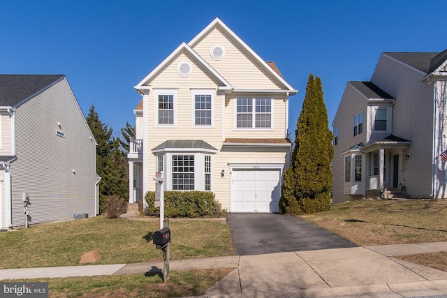 traditional-style home featuring driveway, a front lawn, and a garage