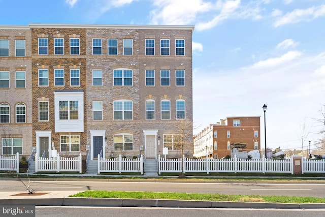 view of building exterior featuring a fenced front yard