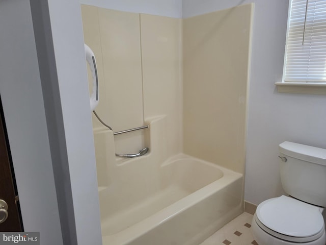 bathroom with a shower, a tub to relax in, toilet, and baseboards