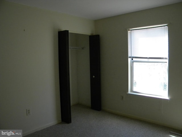 spare room featuring light colored carpet