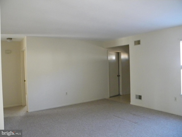 unfurnished room with light carpet and visible vents