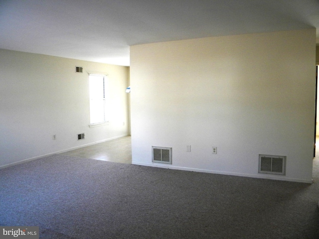 empty room featuring carpet and visible vents